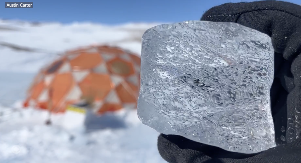 Researcher holds up a piece of ice in Antarctica